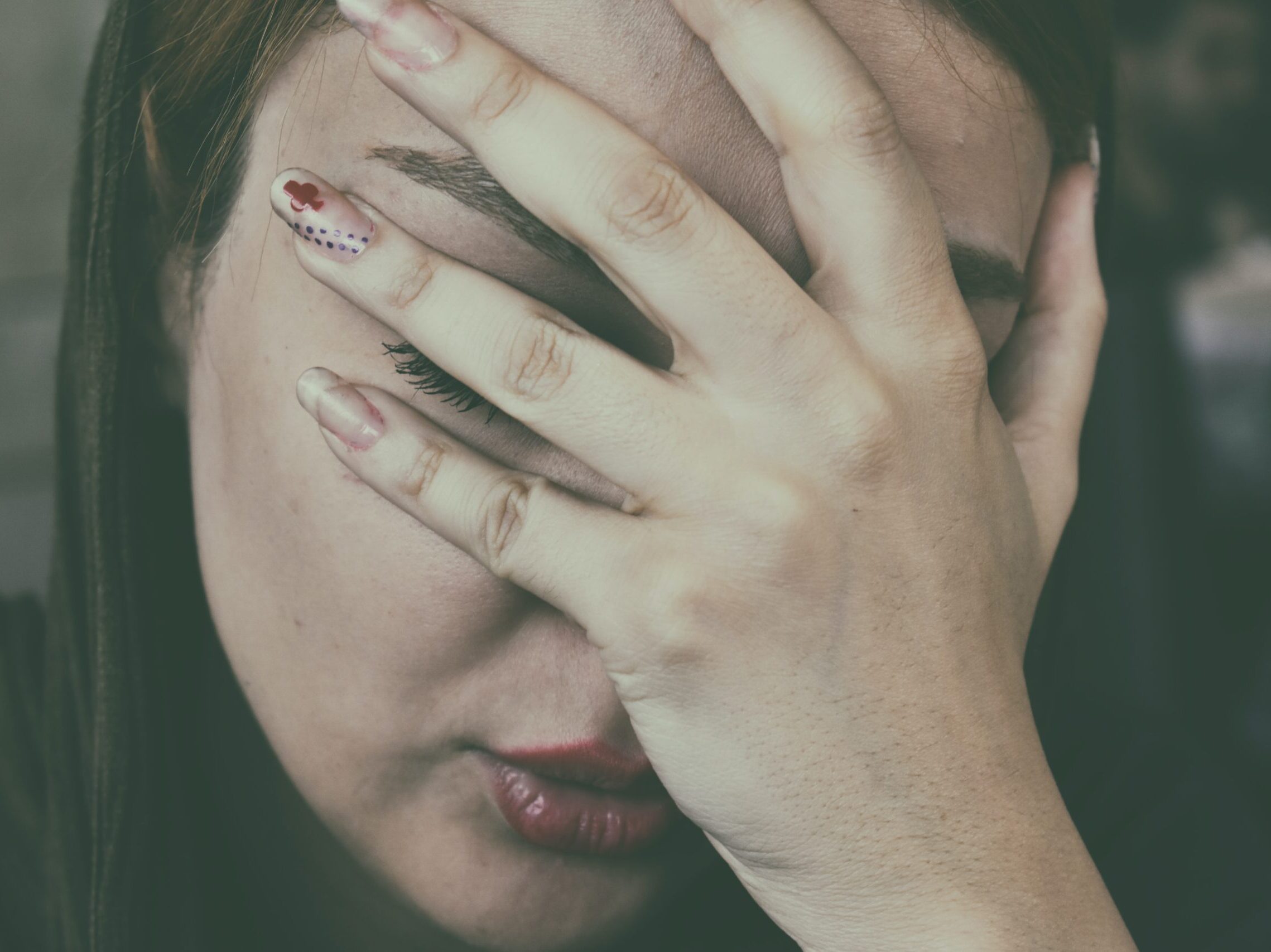 woman's hand on face
