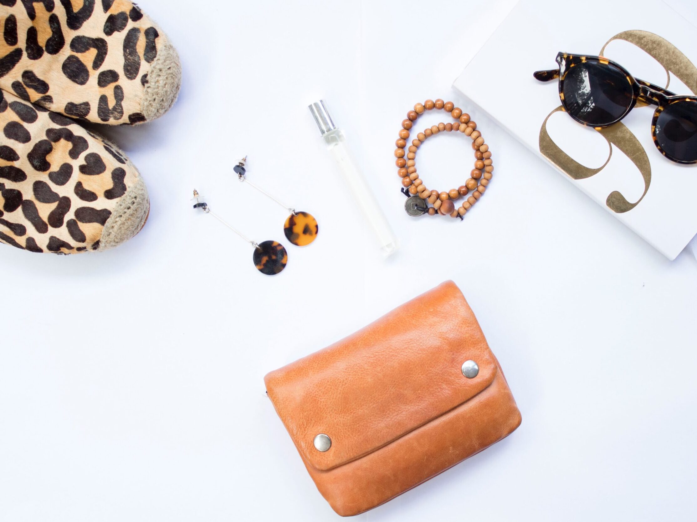 tortoiseshell Clubmaster-style sunglasses near beaded brown necklace