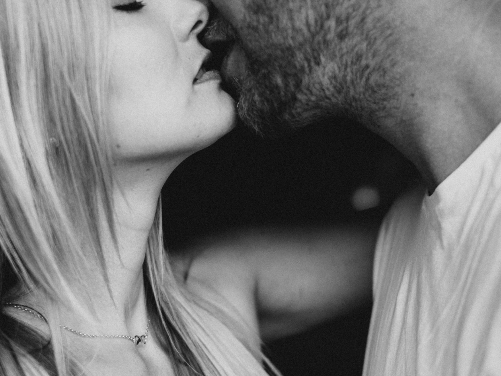 grayscale photography of man and woman kissing