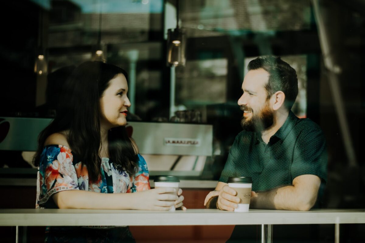 couple drinking coffee inside coffee shop