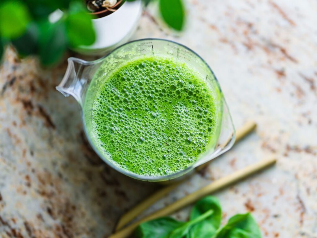 pitcher of green beverage