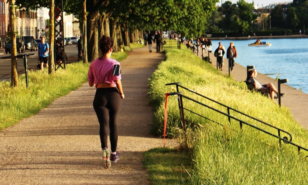 woman jogging near body of water