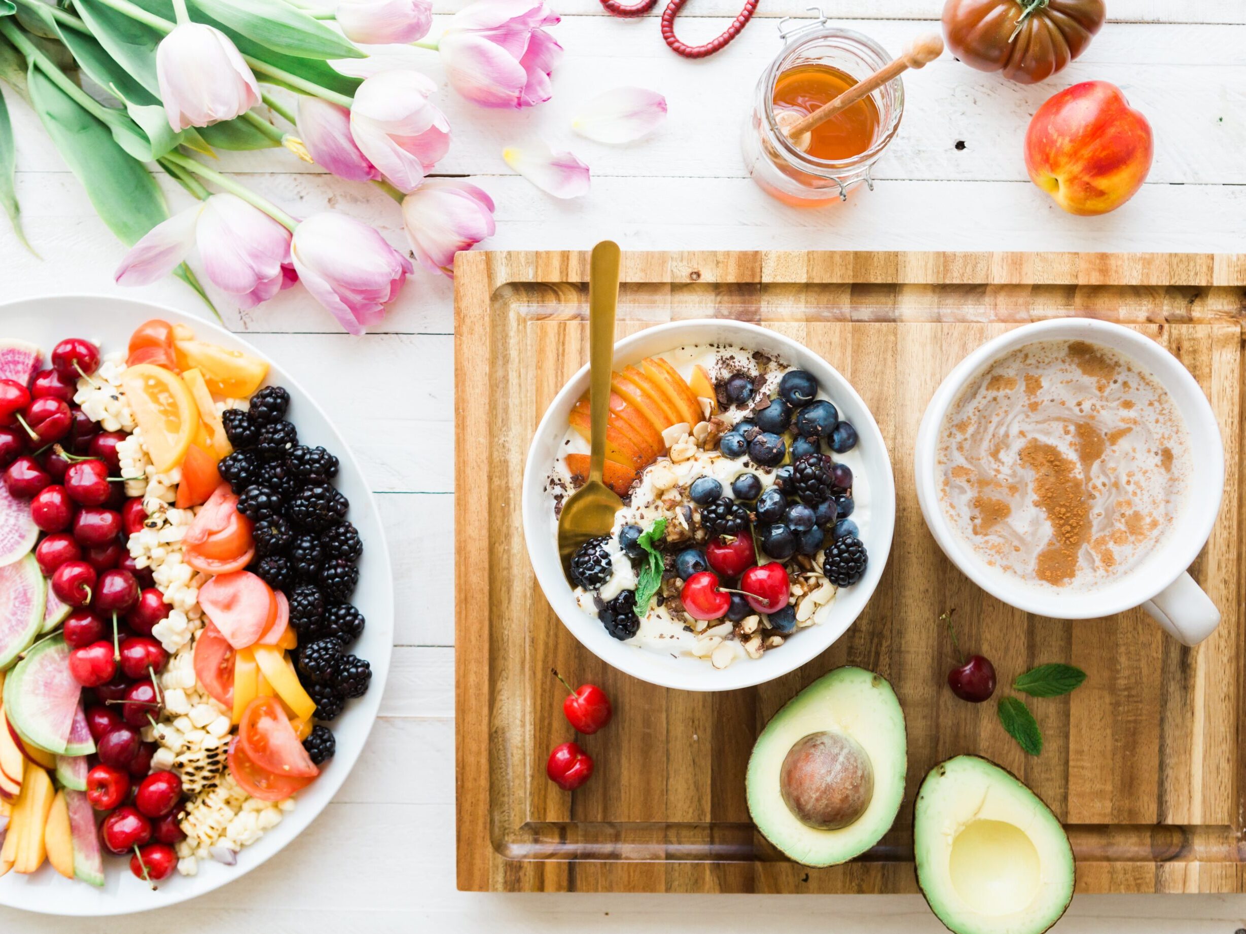 black and red cherries on white bowl