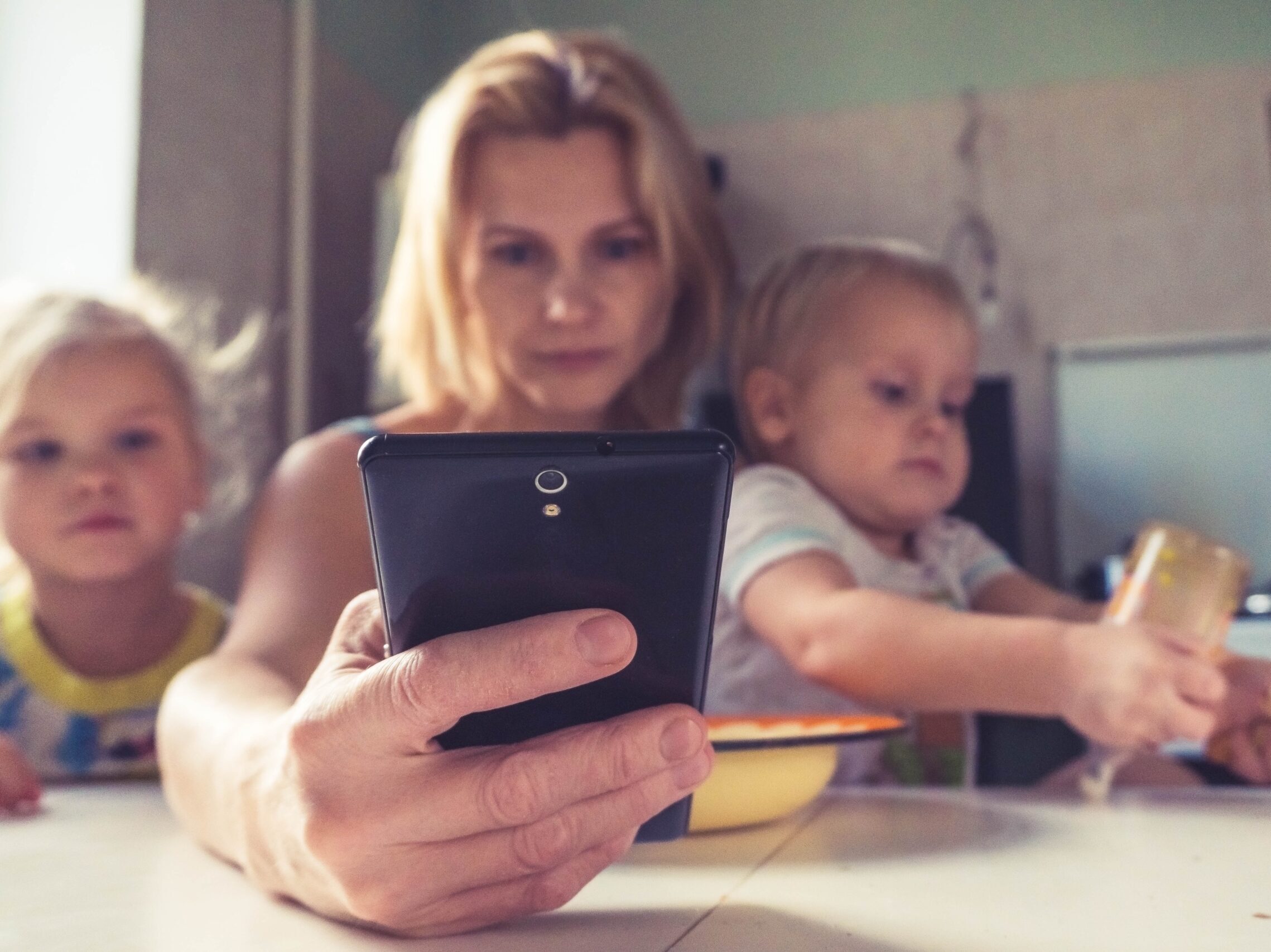 woman in white shirt holding black ipad