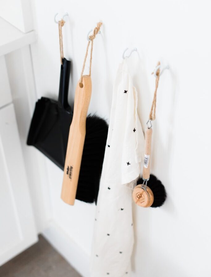 three black and brown bathroom cleaning tools