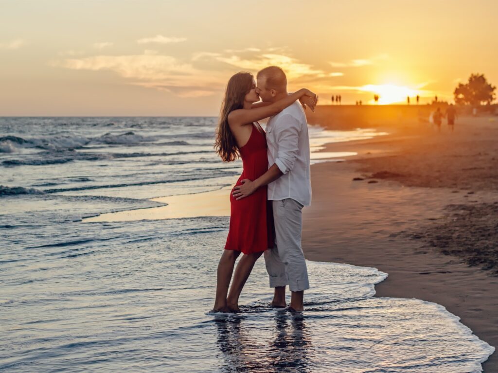 man kissing woman in seashore