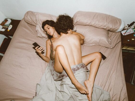 Couple having sex and using smartphone