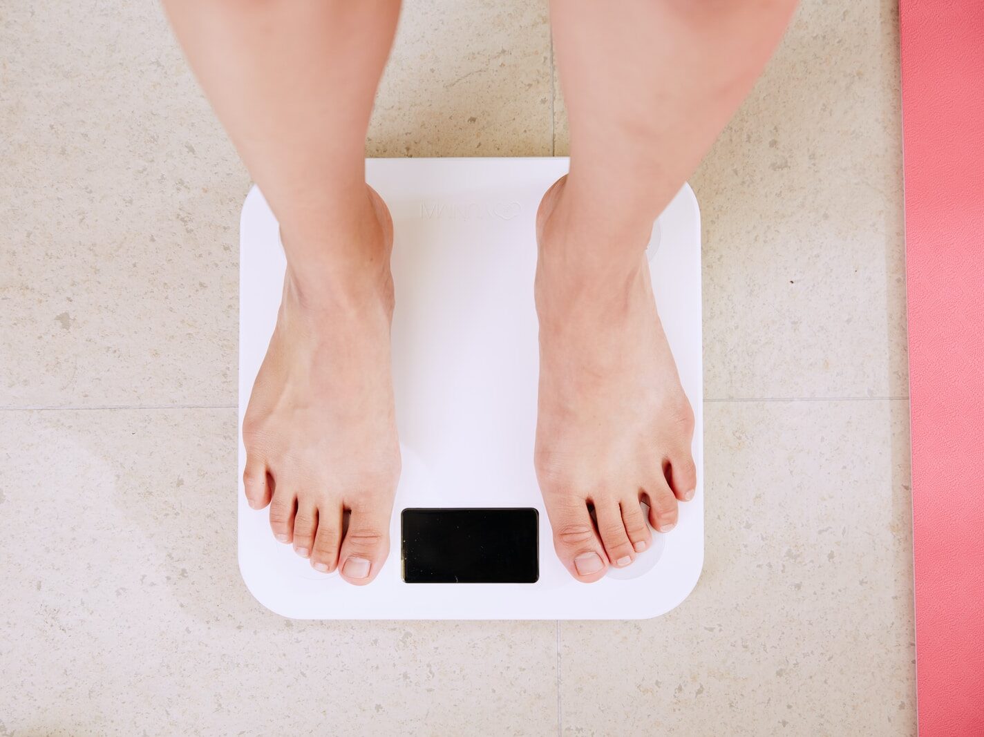 person standing on white digital bathroom scale