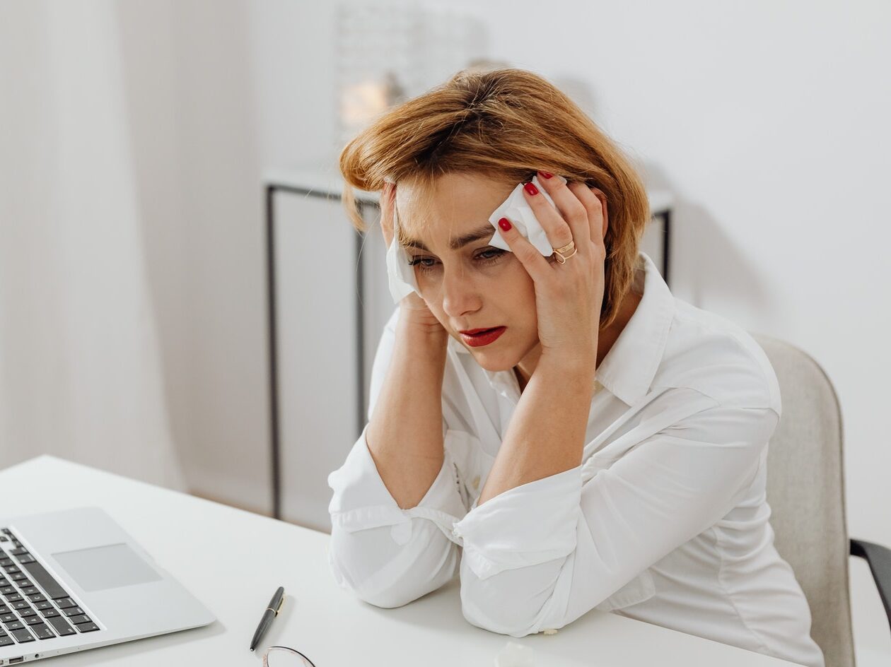 Woman Sitting at a Table Crying