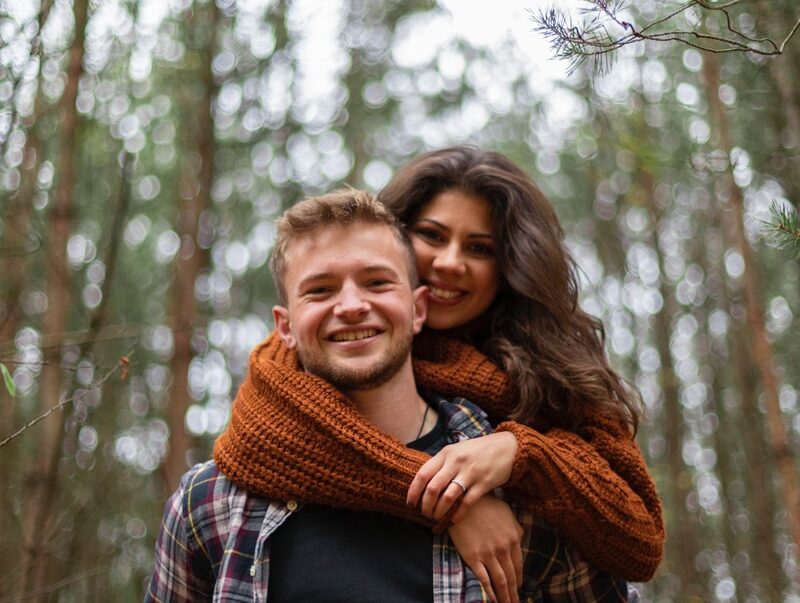 woman in blue and white plaid scarf smiling