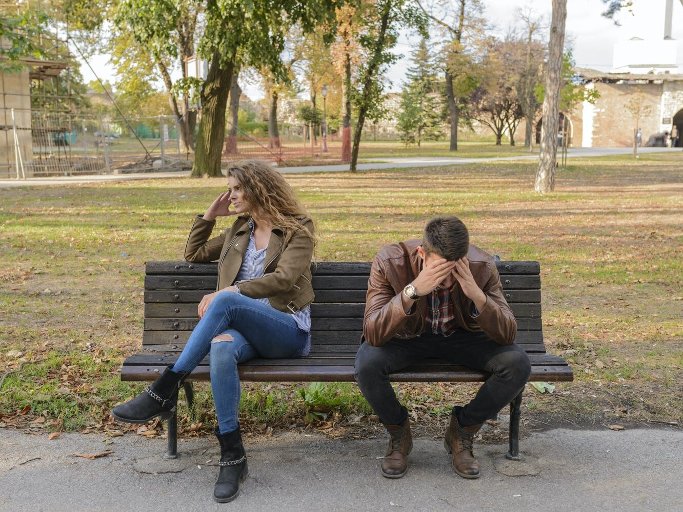 Woman And Man Sitting on Brown Wooden Bench