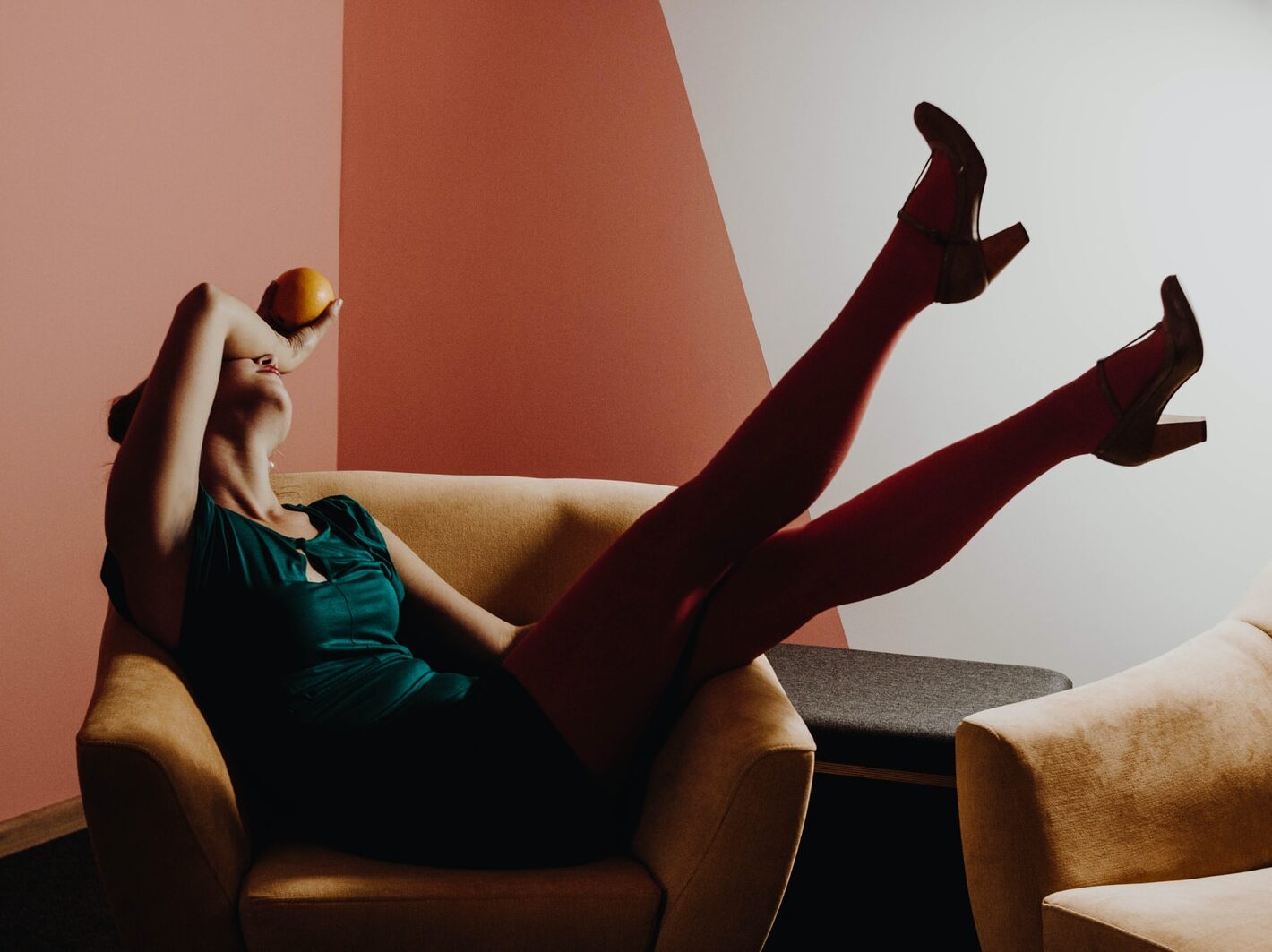 woman sitting on brown armchair