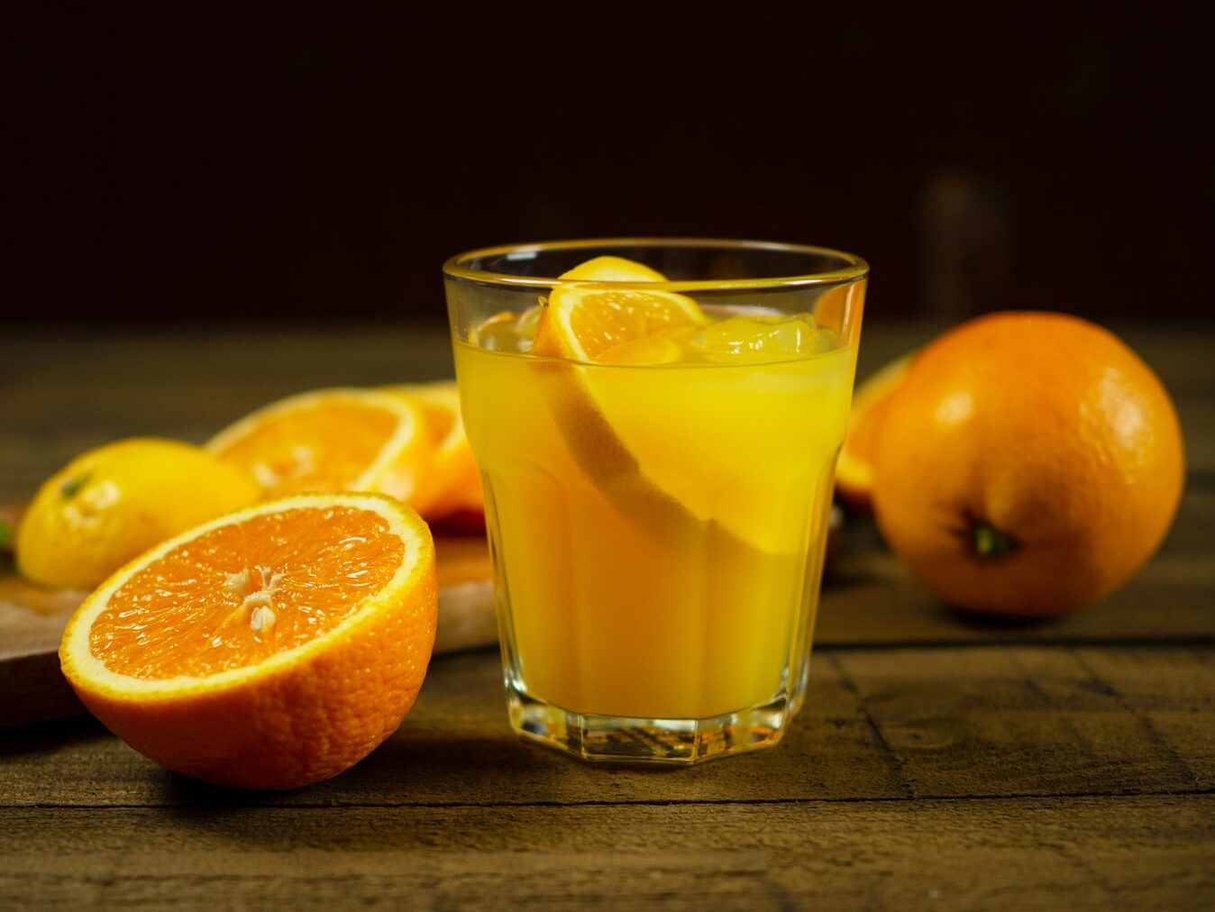 orange juice in clear drinking glass