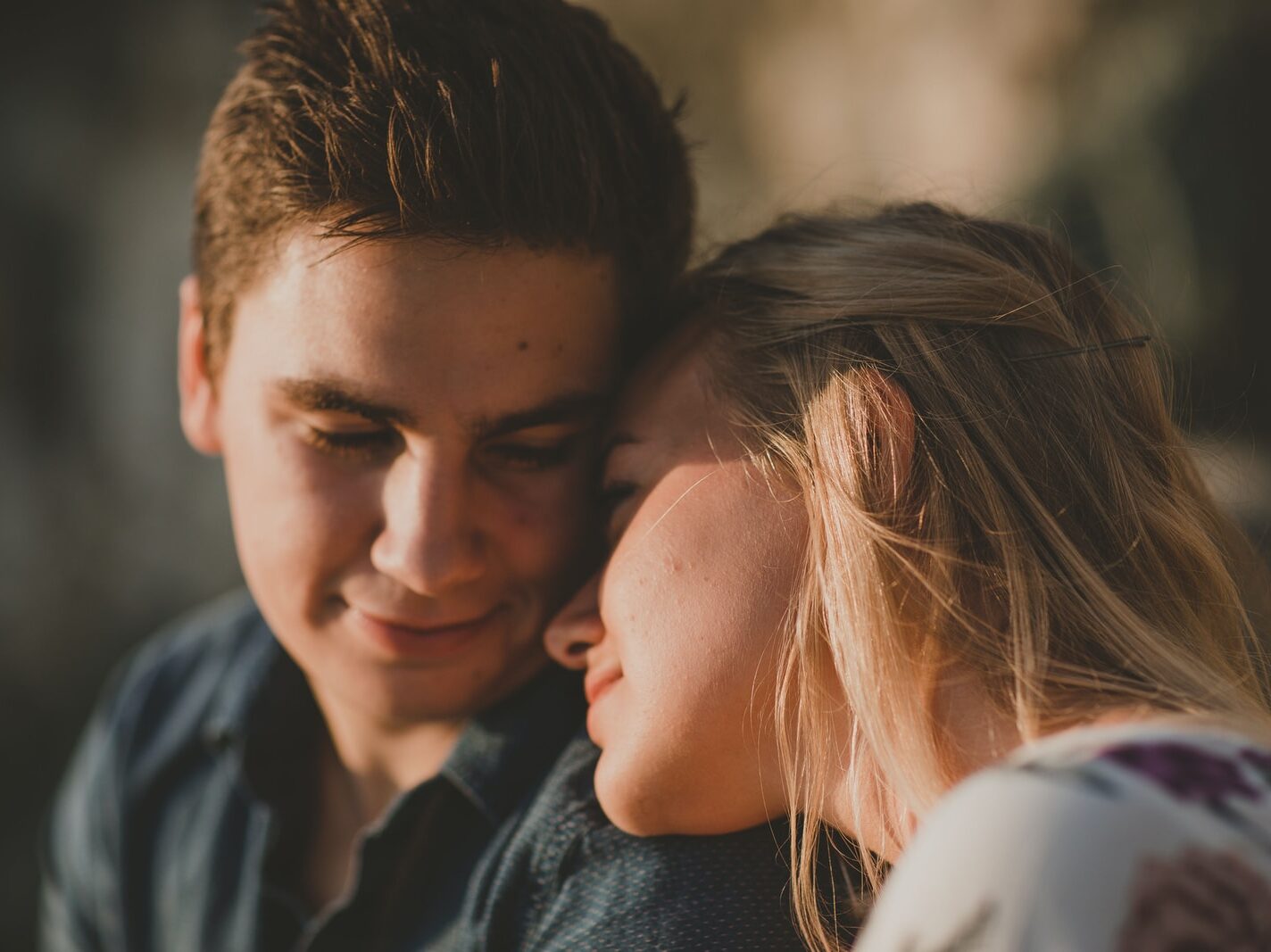 woman leaning on man's shoulder