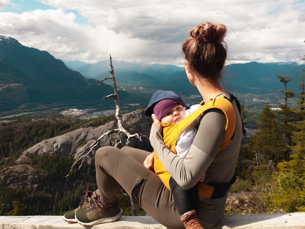 Mother Carrying Her Baby while Looking at the Nature Scenery