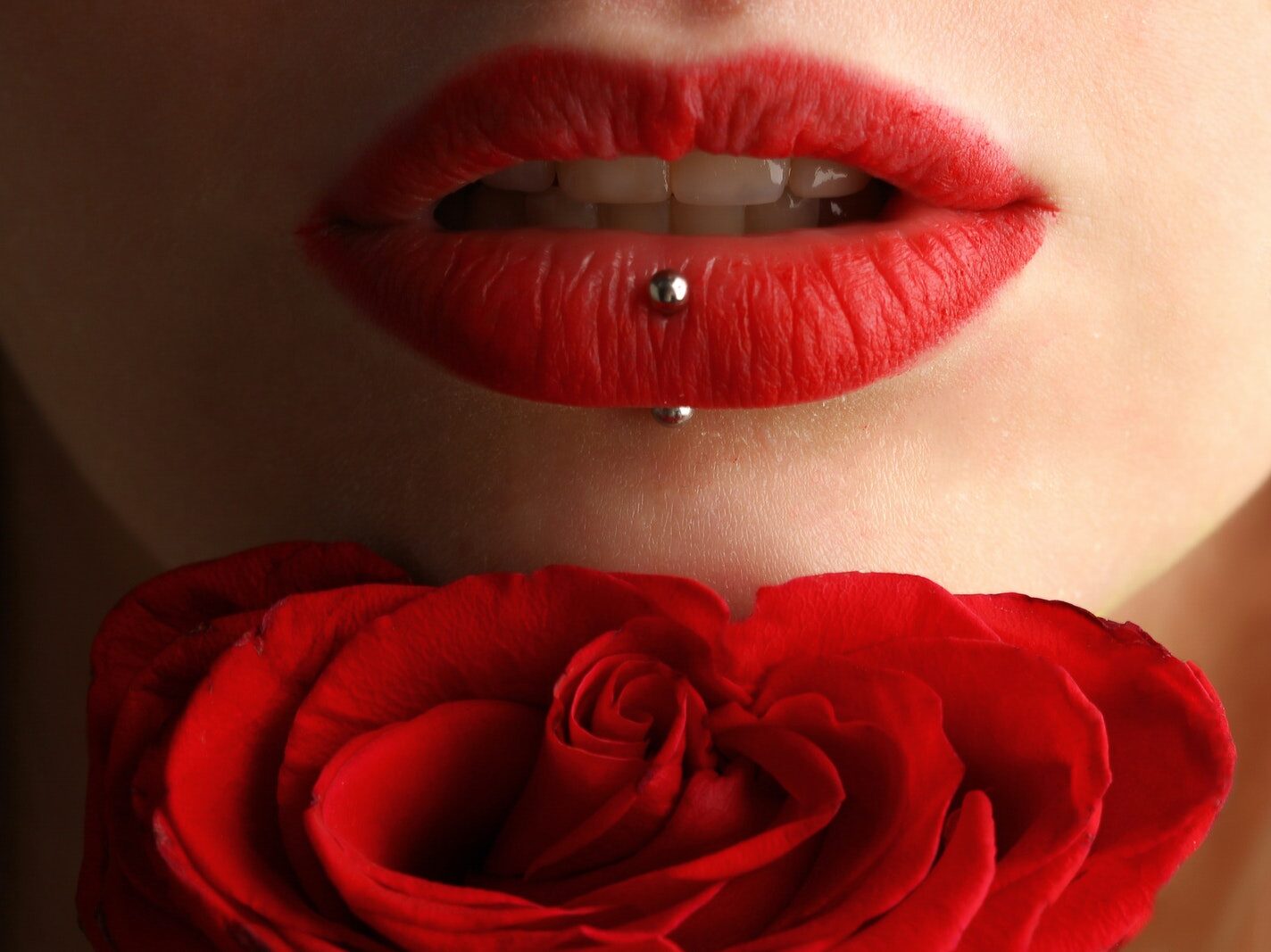 Woman Wearing Red Lipstick Near Red Rose