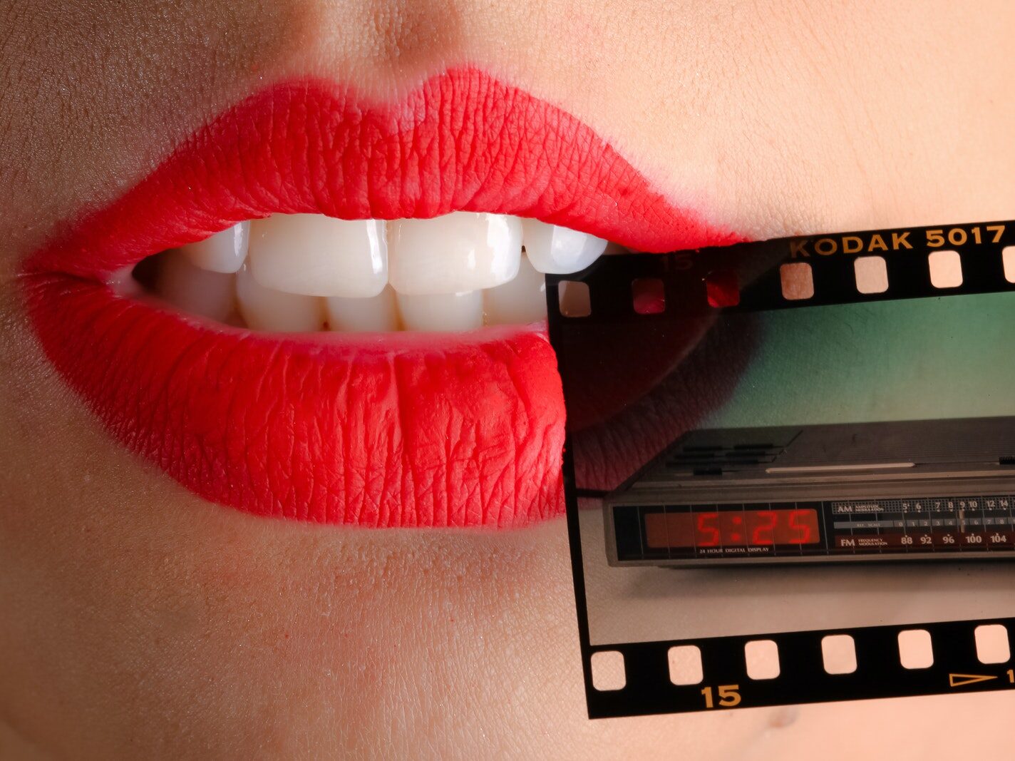 Person Wearing Red Lipstick Biting Film