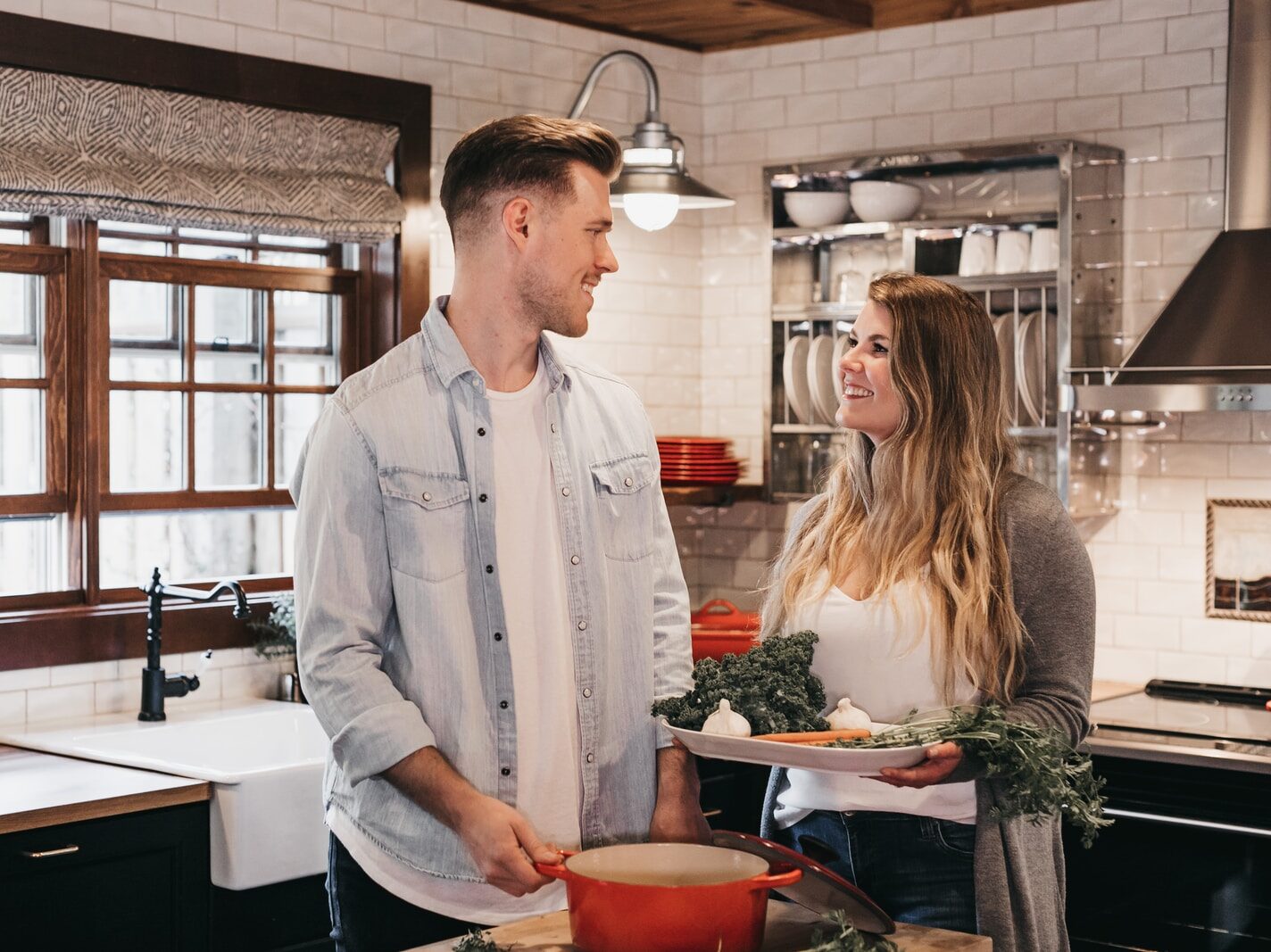 man and woman standing inside kitchen room
