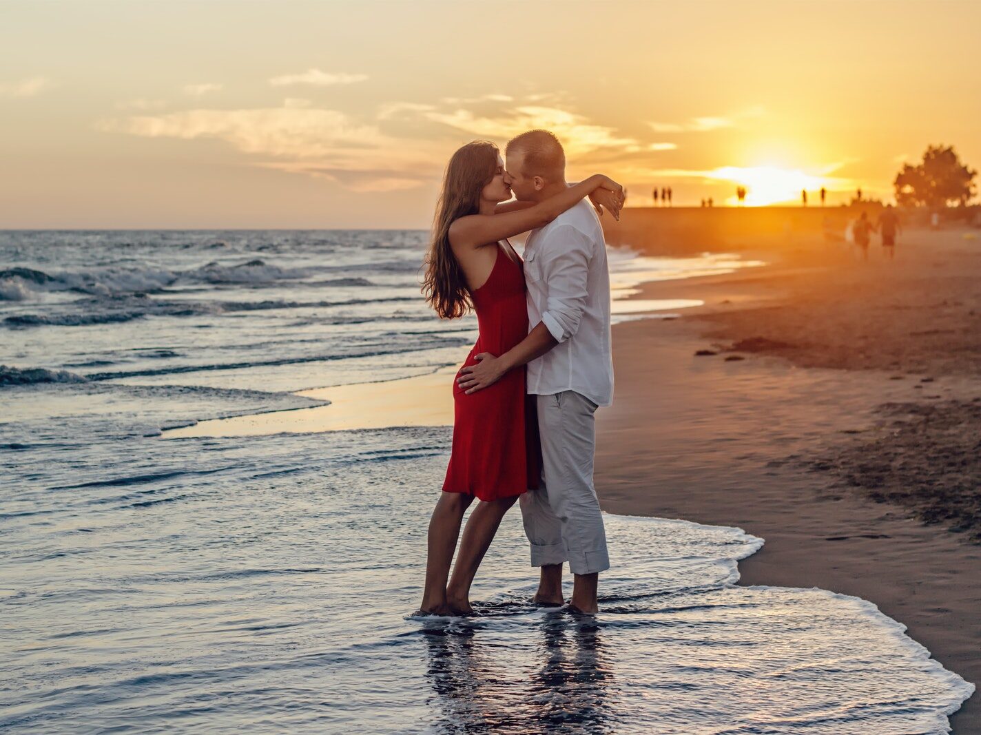 Couple Kissing on Beach during Golden Hour