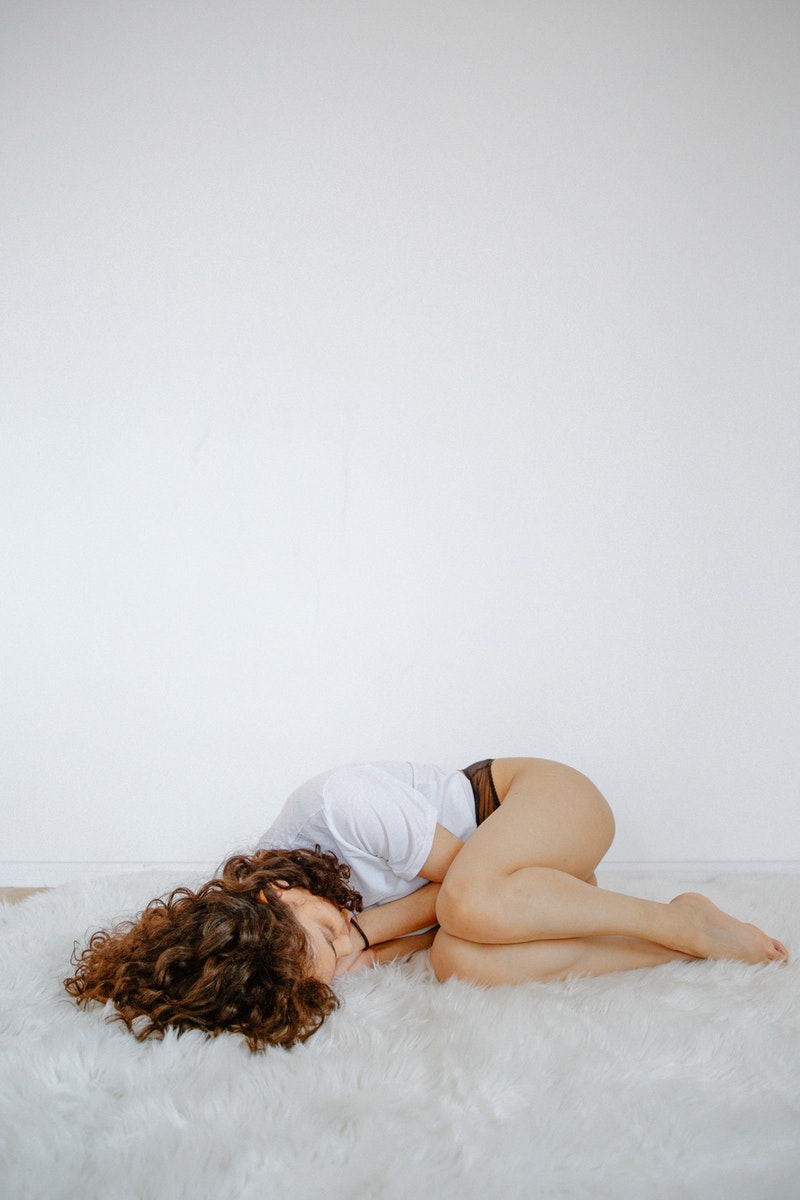 Woman Curled Up on Floor