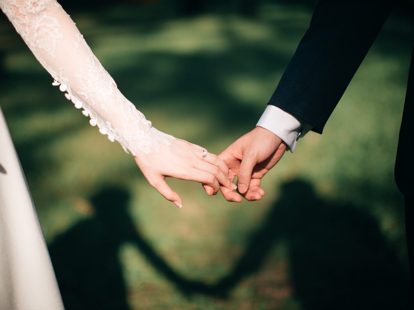 man and woman holding hands focus photo