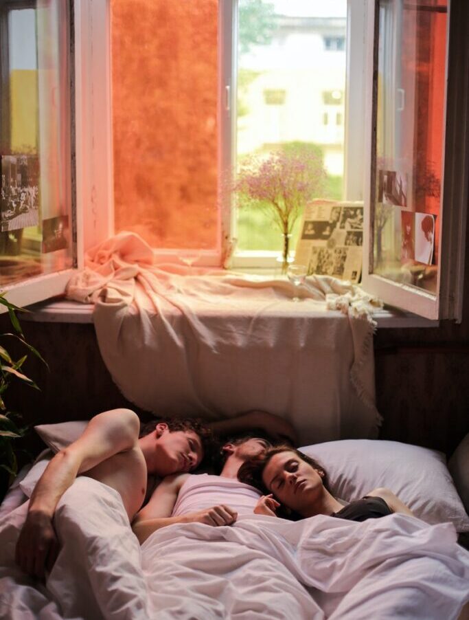 Woman in Black Tank Top Lying on Bed