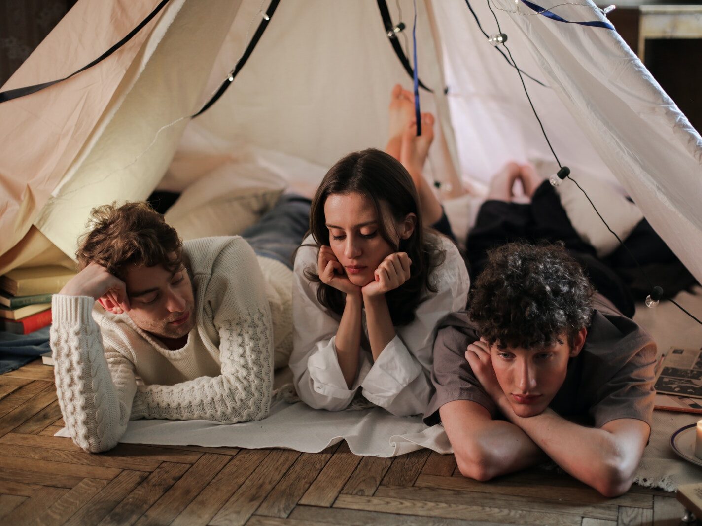 Man and Woman Sitting on Brown Wooden Floor