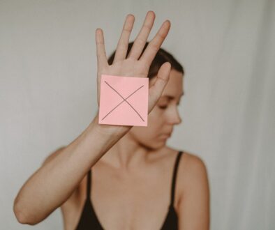 Woman with paper with cross sign