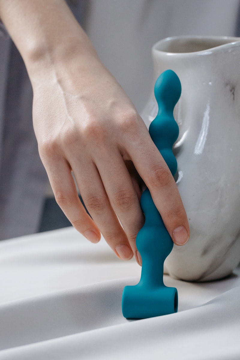 Person Holding Blue Plastic Toy