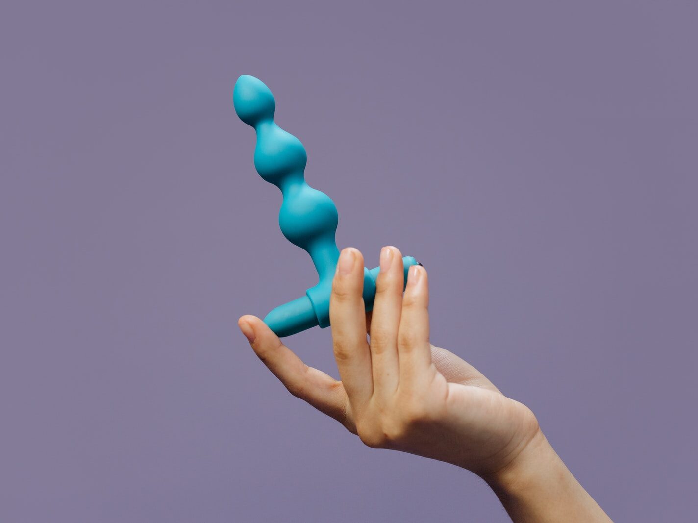 Person Holding Blue Plastic Balloon