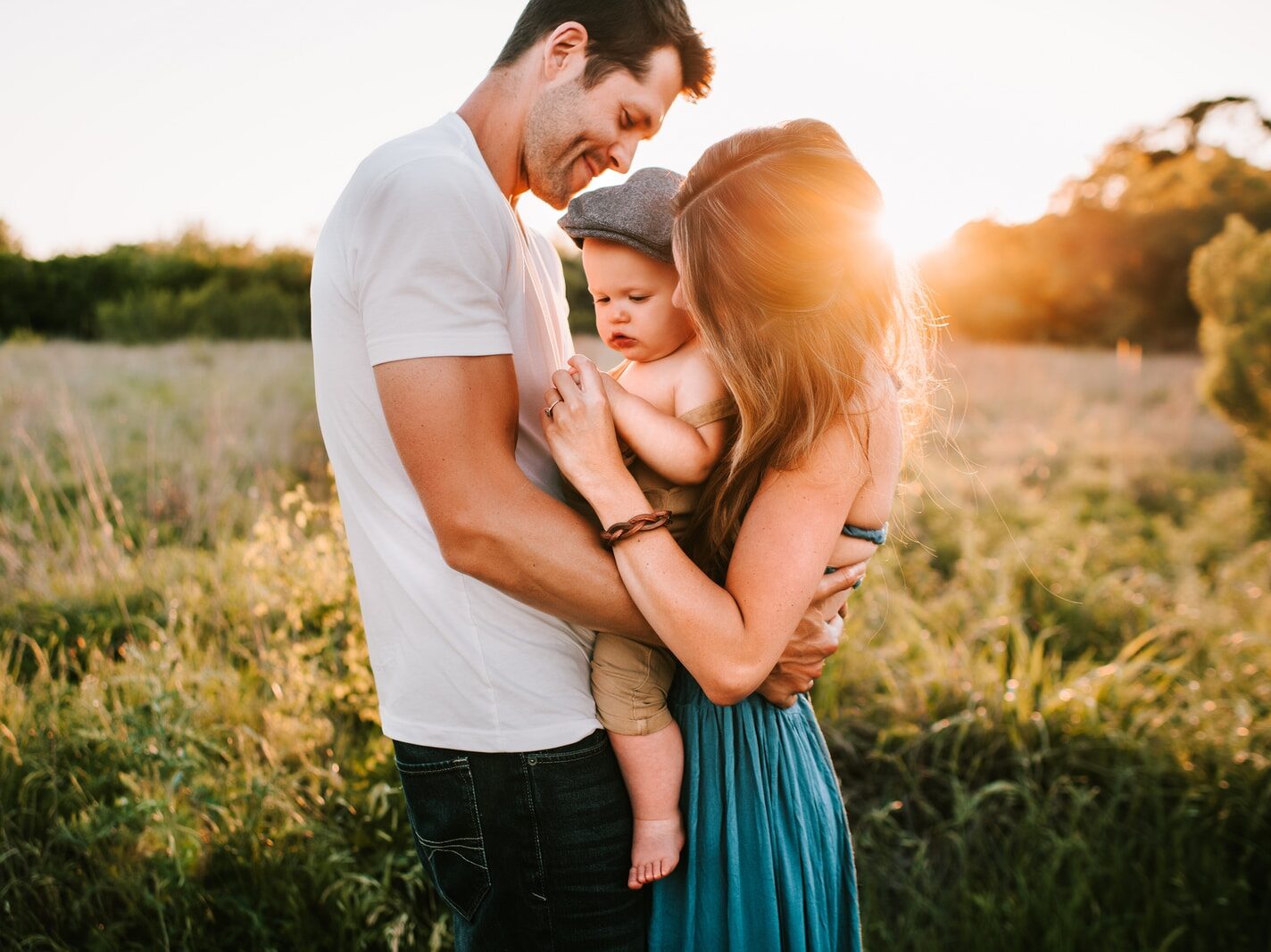 family photo on green grass during golden hour