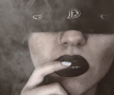 Blindfolded Woman With Finger on Lips Grayscale Portrait