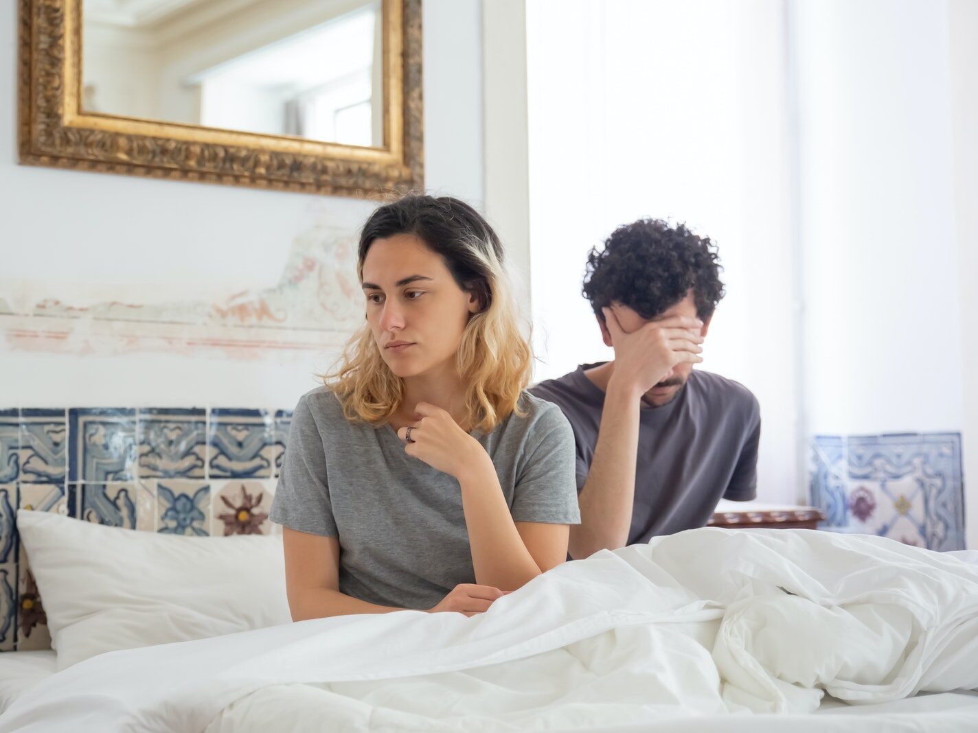 Woman in Gray Shirt Sitting Beside Man