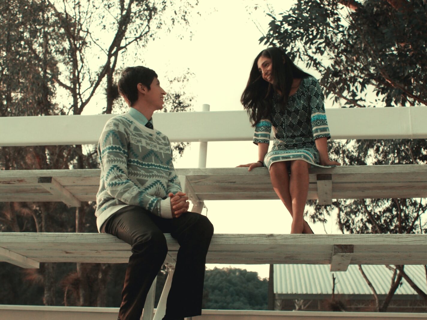 man and woman sitting on bench during daytime