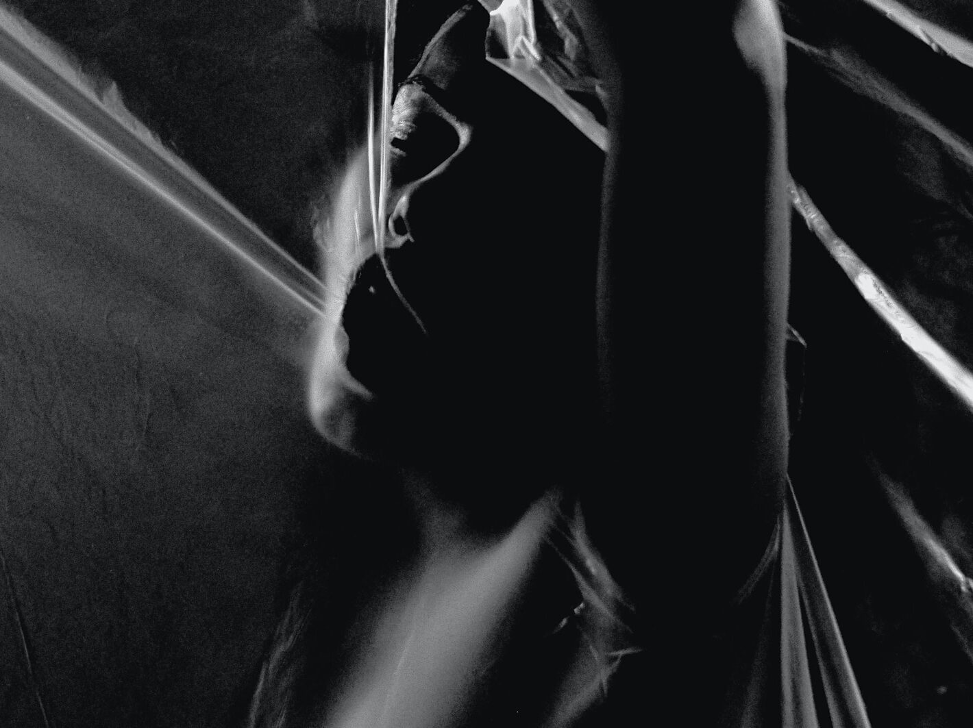 grayscale photography of woman opening her mouth