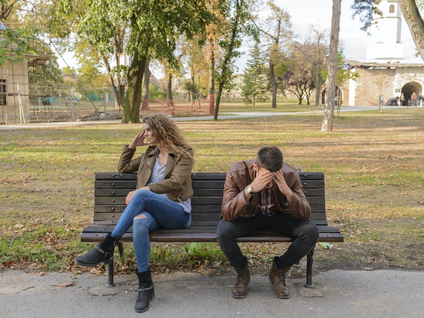 Woman And Man Sitting on Brown Wooden Bench