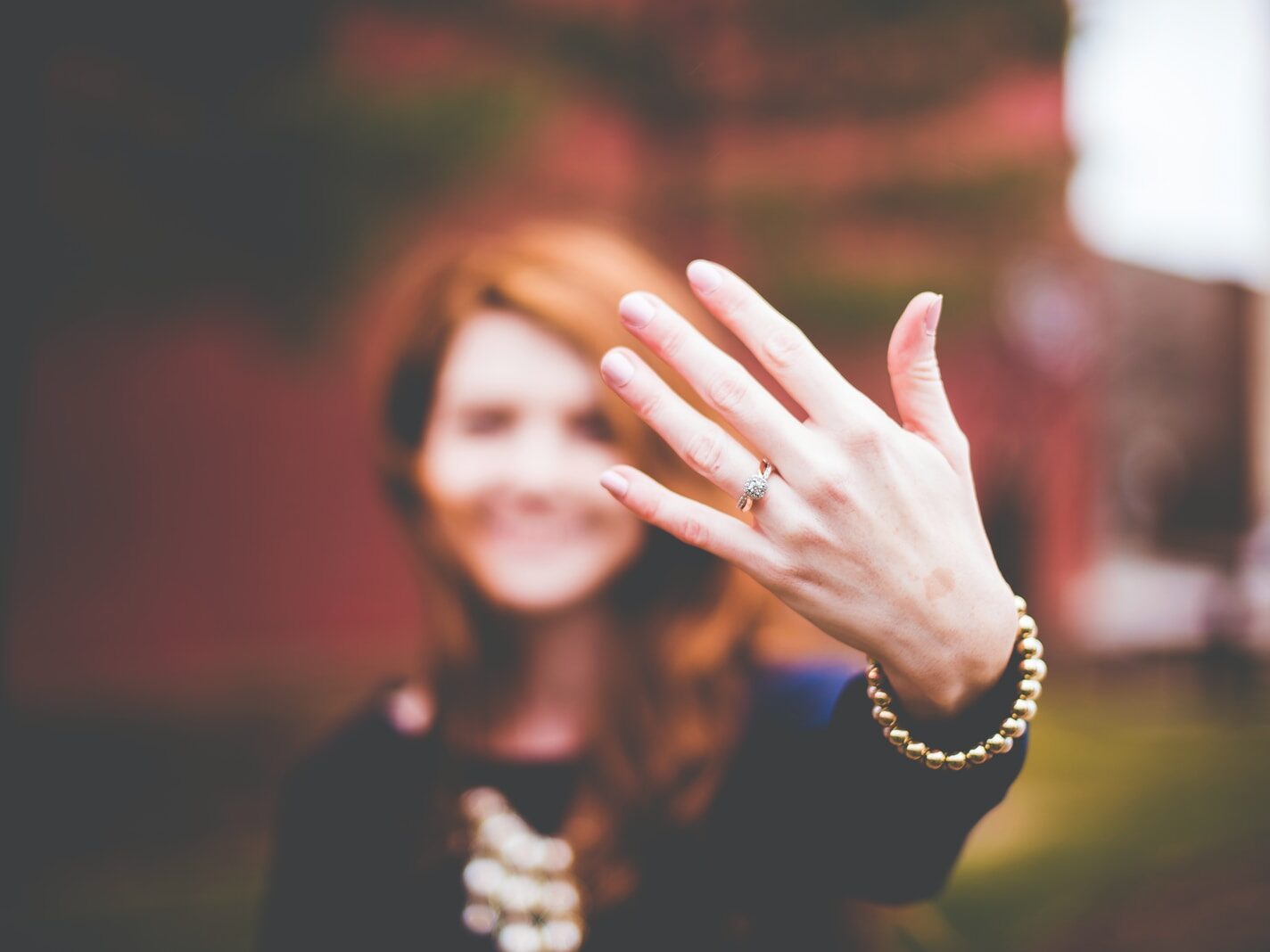 woman showing silver-colored ring