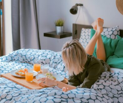 woman lying on bed white holding board