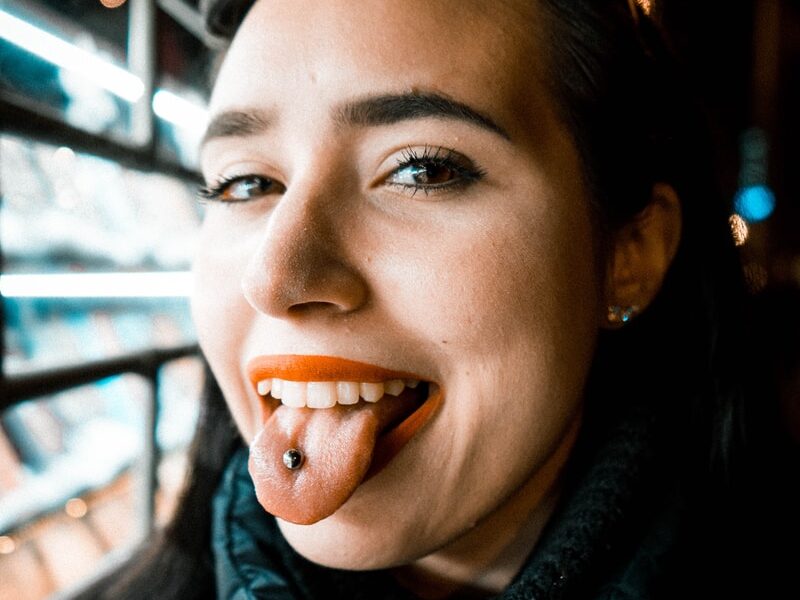 woman showing tongue with piercing