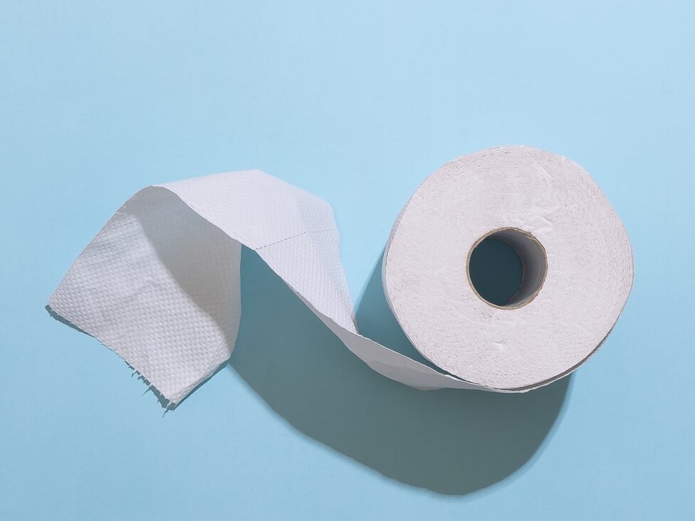 white toilet paper roll on white table