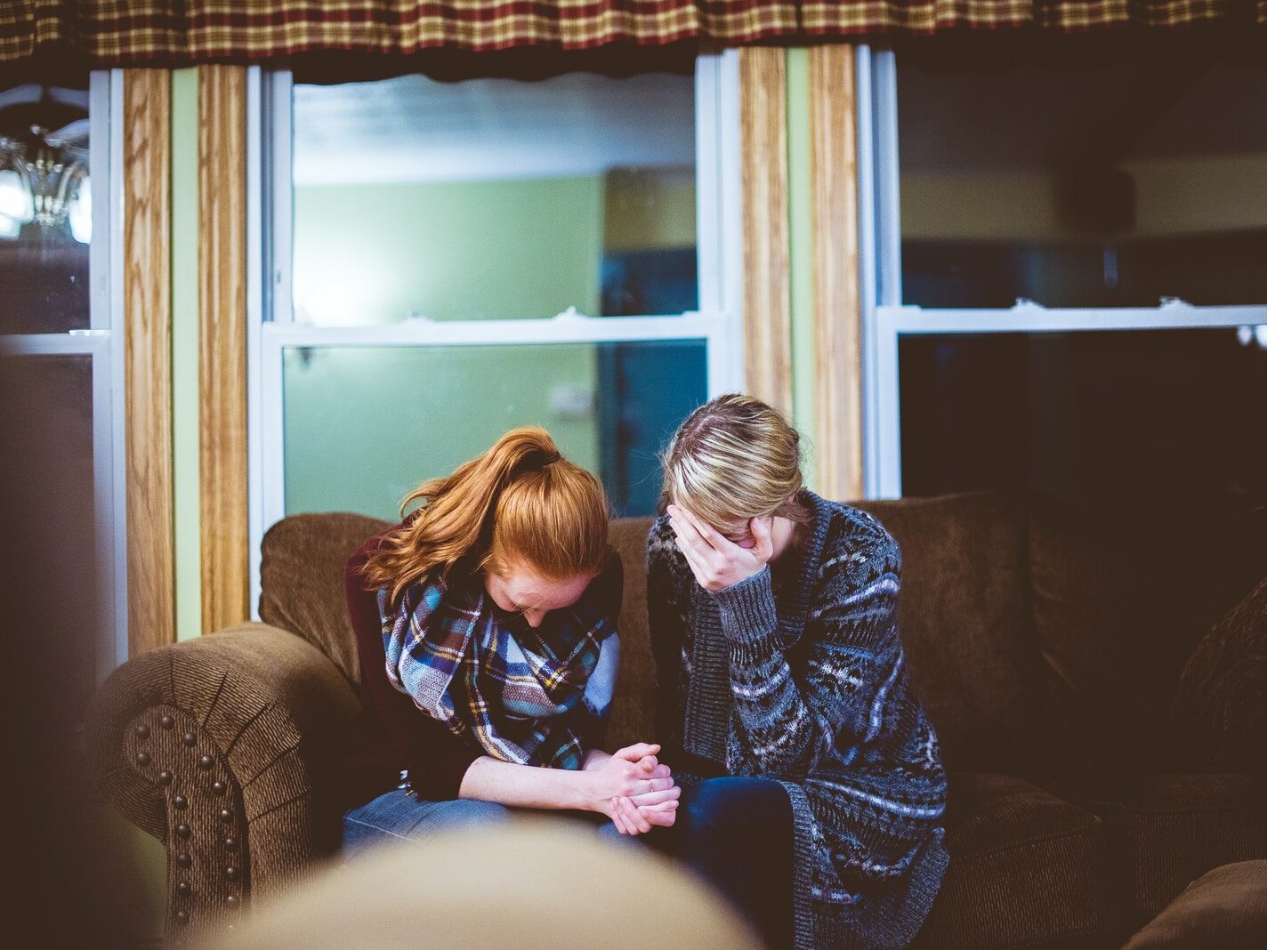 man and woman sitting on sofa in a room