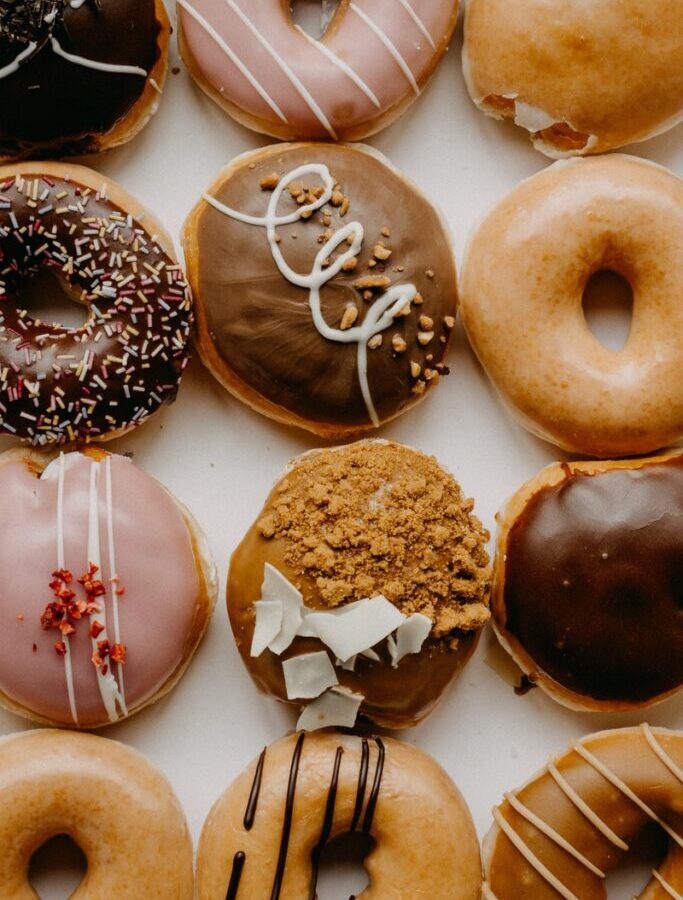 brown and white doughnuts on white ceramic plate