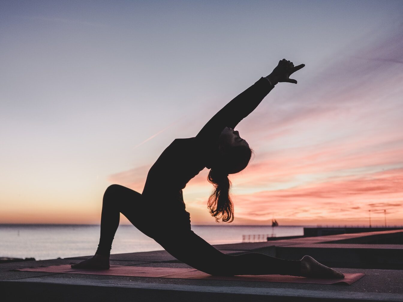 silhouette photography of woman doing yoga