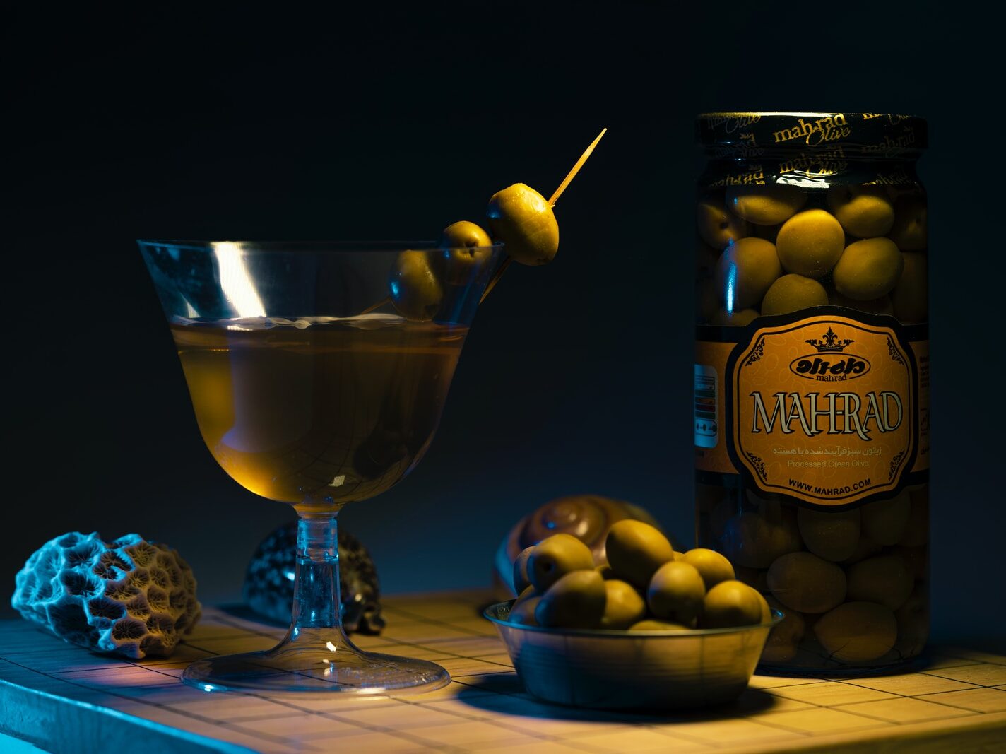 blue wine glass with yellow liquid inside