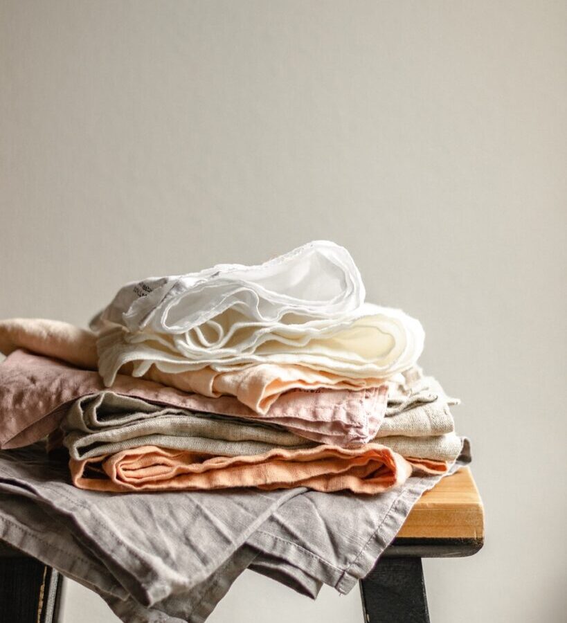 white textile on brown wooden table