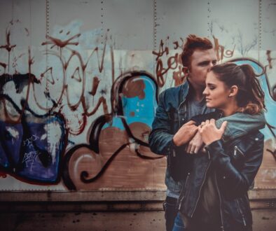 man hugging woman and kissing her on head