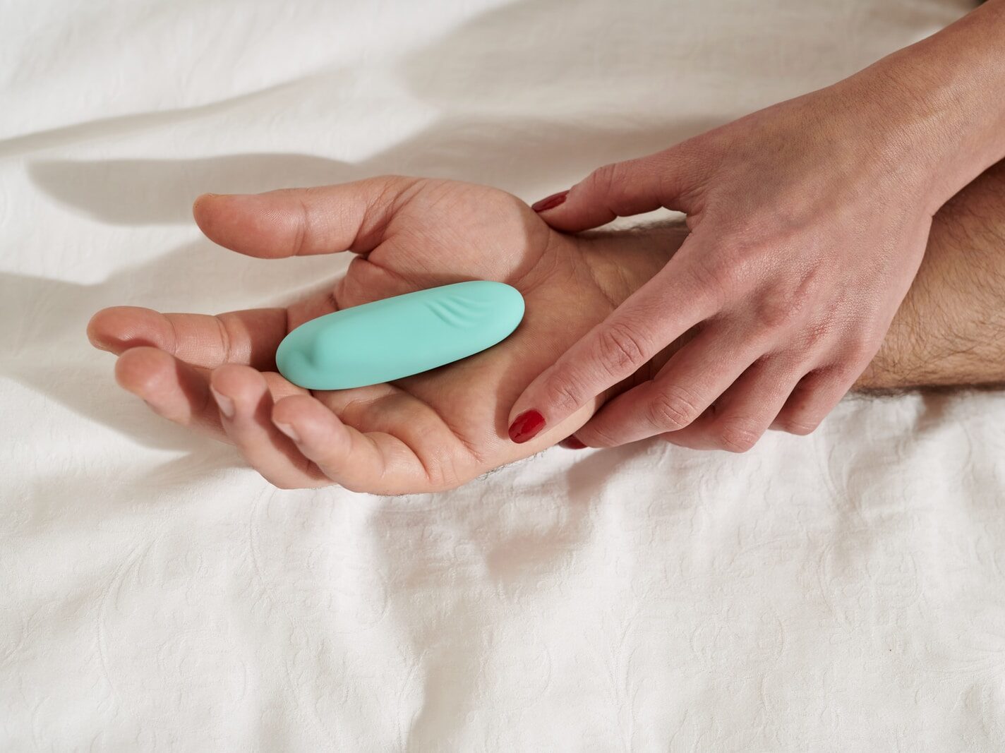 persons hand on white textile