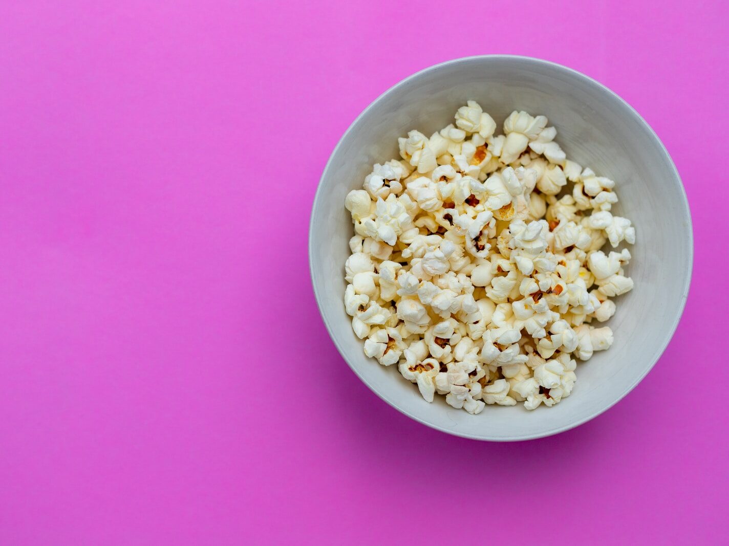 white ceramic bowl on pink textile