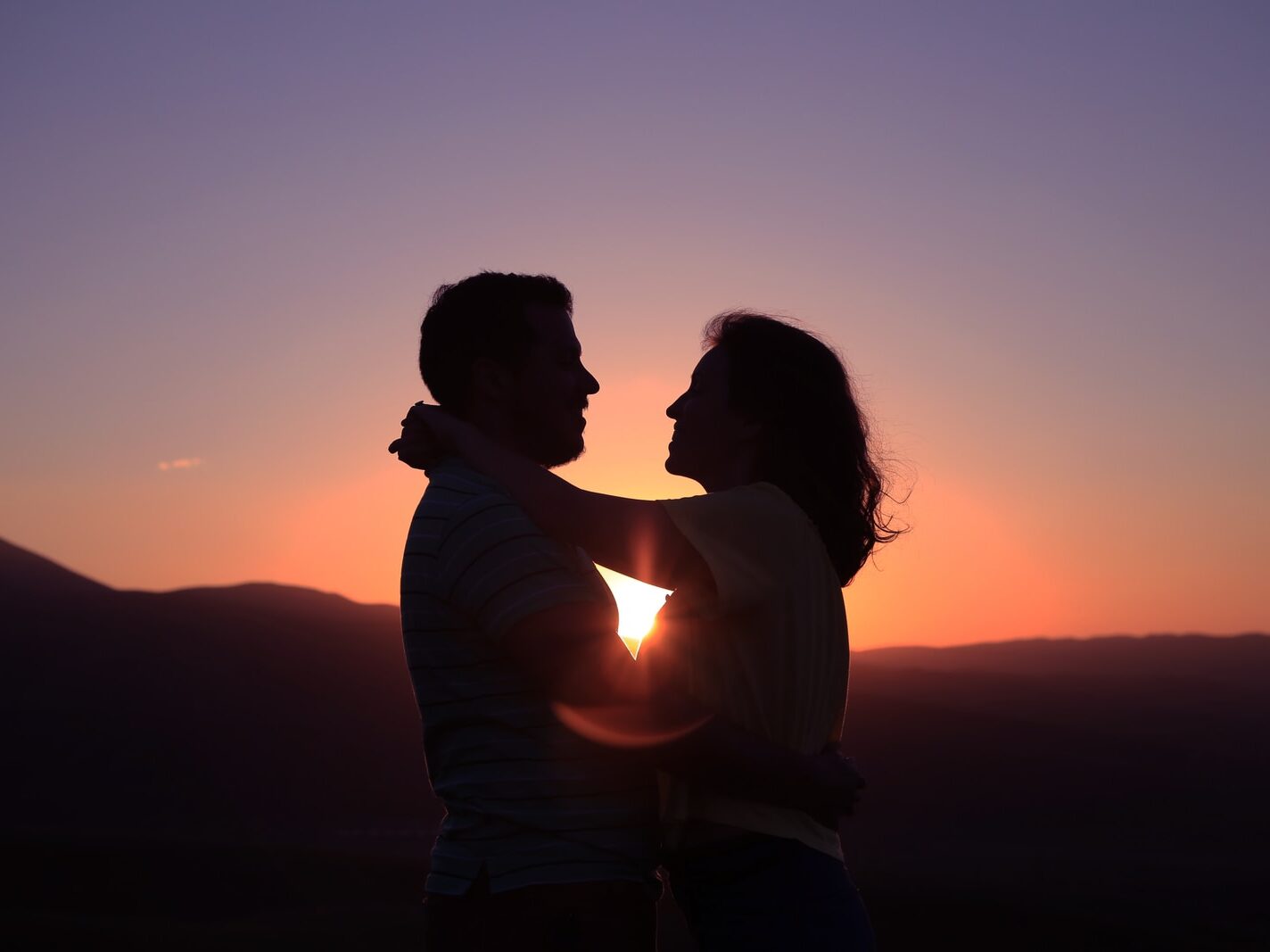 silhouette of hugging couple