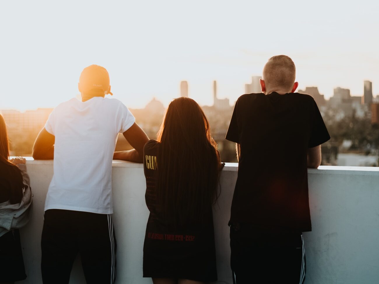 four person looking at the city